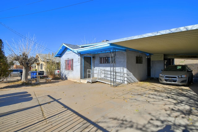 back of house with a carport