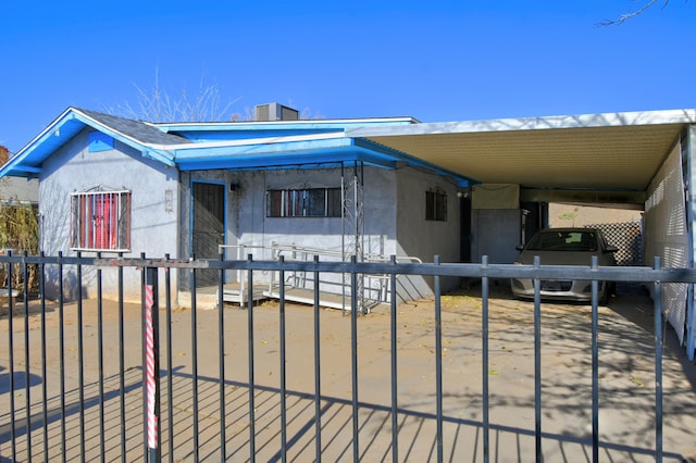 view of front of property featuring a carport