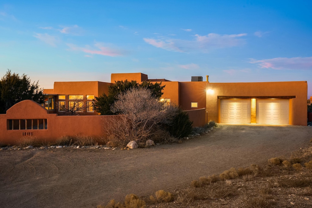 pueblo-style house with a garage