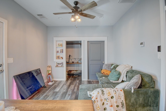 living area with ceiling fan and wood-type flooring