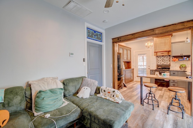 living room featuring ceiling fan and light hardwood / wood-style flooring