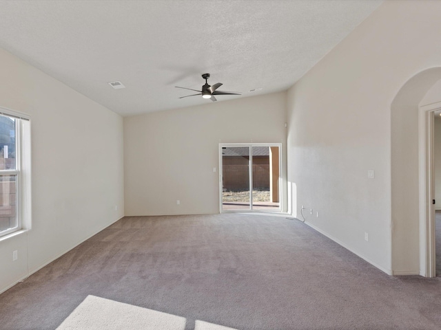 6409 Osprey Dr NE, Rio Rancho, NM 87144 - spare room featuring a textured ceiling, light colored carpet, plenty of natural light, and ceiling fan
