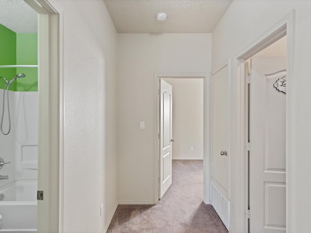 6409 Osprey Dr NE, Rio Rancho, NM 87144 - corridor with light carpet and a textured ceiling