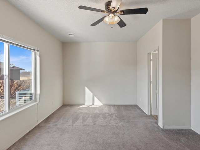 6409 Osprey Dr NE, Rio Rancho, NM 87144 - carpeted empty room with a textured ceiling and ceiling fan