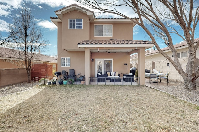 back of property featuring an outdoor living space and a patio