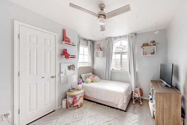 bedroom with ceiling fan and light hardwood / wood-style flooring