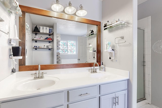 bathroom featuring vanity and an enclosed shower