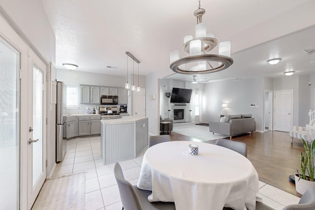 tiled dining space featuring ceiling fan and a textured ceiling