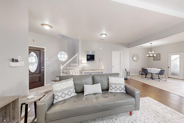 living room with a textured ceiling and light hardwood / wood-style flooring