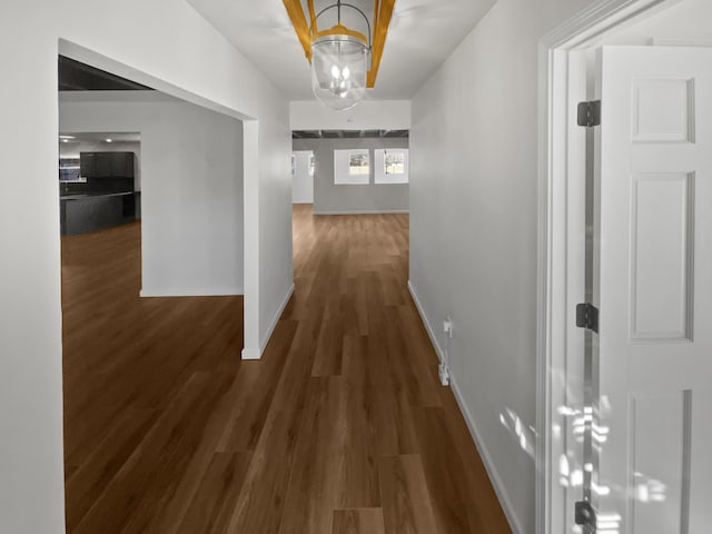 437 El Llano Ln NW, Los Ranchos, NM 87107 - hallway with wood finished floors and a chandelier
