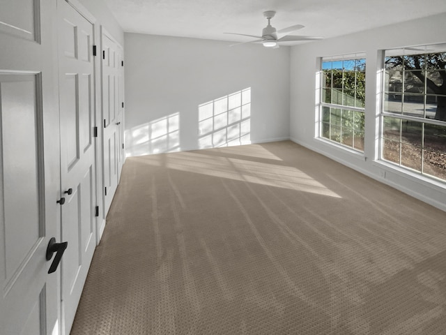 carpeted empty room with ceiling fan