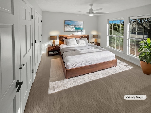 carpeted bedroom featuring ceiling fan