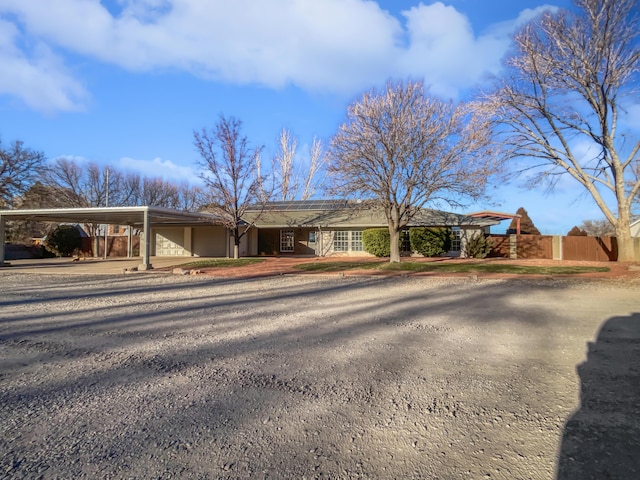 437 El Llano Ln NW, Los Ranchos, NM 87107 - view of front of home with an attached carport, driveway, and solar panels