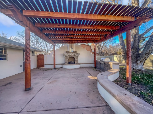 view of patio / terrace featuring an outdoor stone fireplace, an outdoor kitchen, and a pergola