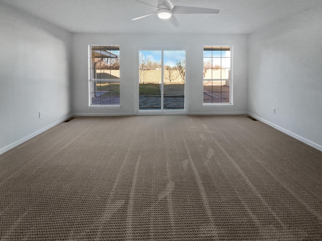 spare room featuring carpet flooring and ceiling fan