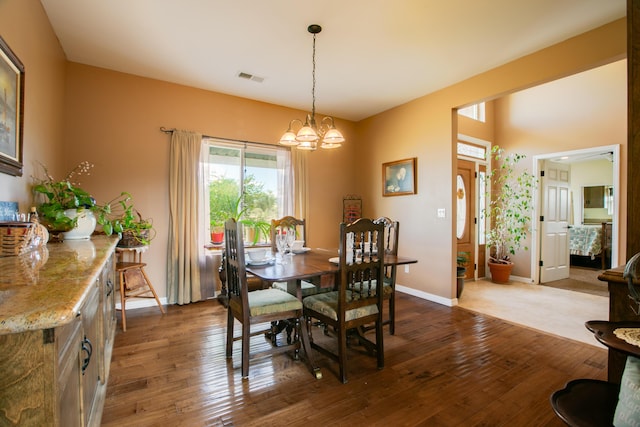 dining area with a chandelier and hardwood / wood-style flooring