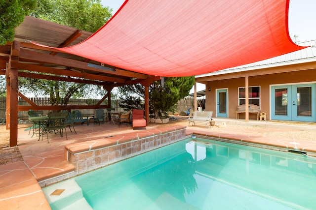 view of pool with a patio area and french doors