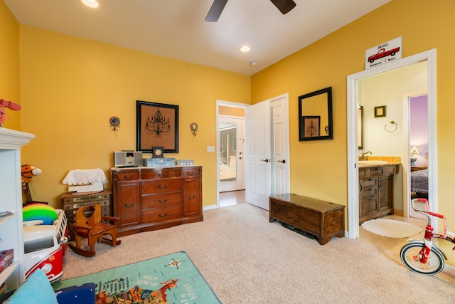 playroom with ceiling fan, sink, and light colored carpet