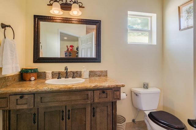 bathroom with vanity and toilet