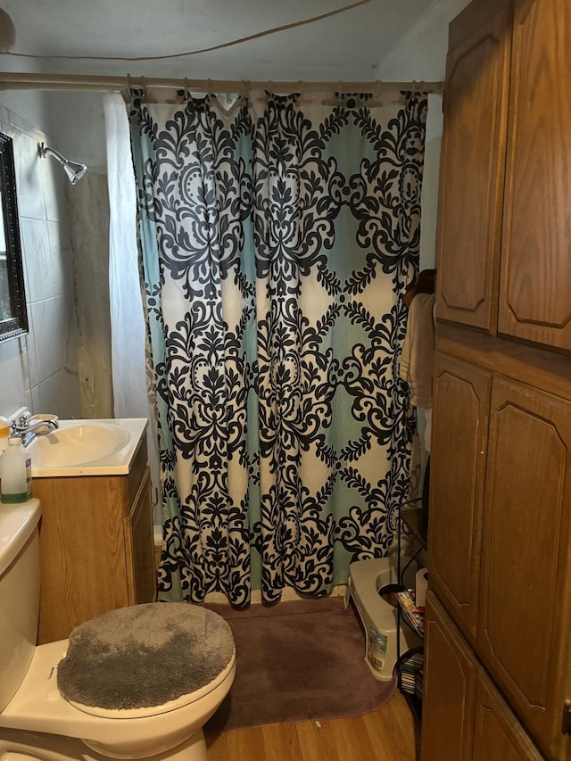 bathroom with hardwood / wood-style floors, curtained shower, and toilet