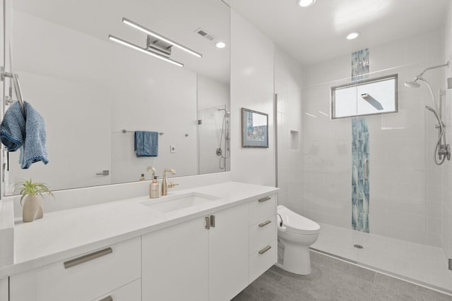 bathroom featuring walk in shower, vanity, and toilet