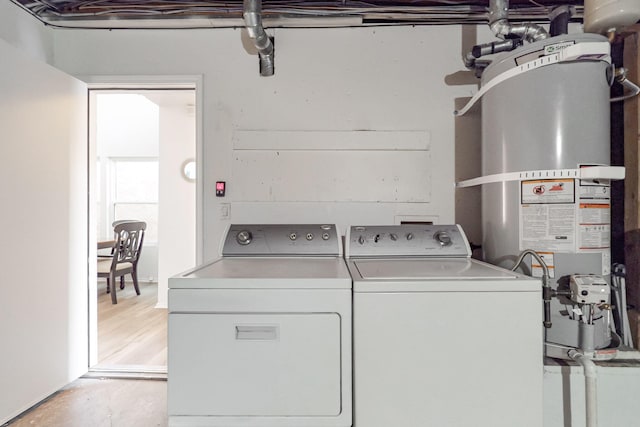 washroom with separate washer and dryer and strapped water heater