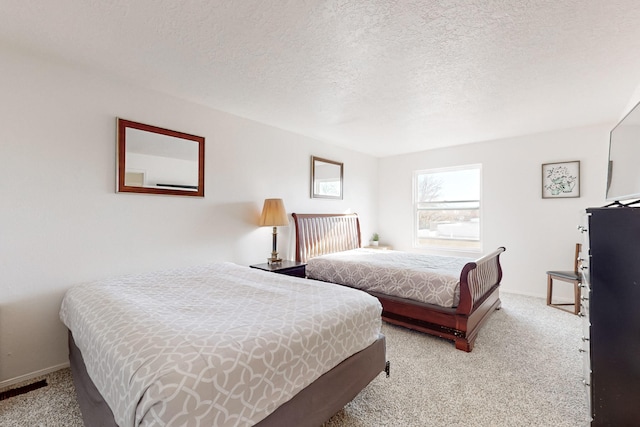 carpeted bedroom featuring a textured ceiling