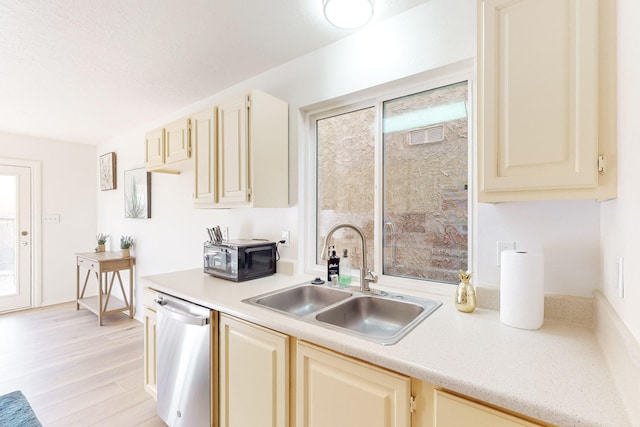 kitchen with dishwasher, light hardwood / wood-style flooring, a healthy amount of sunlight, and sink