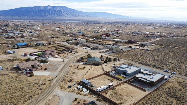 drone / aerial view with view of desert and a mountain view