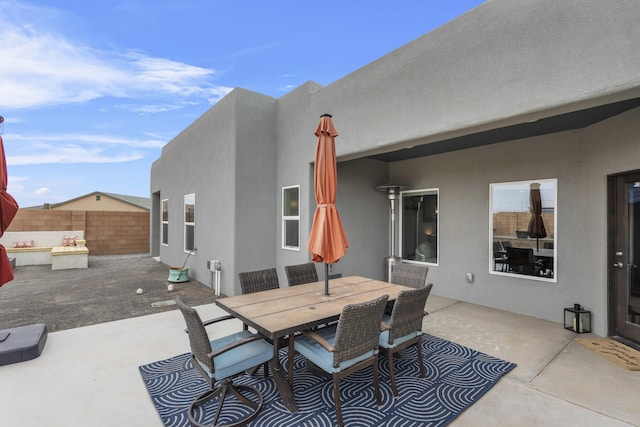 view of patio / terrace featuring outdoor dining area and fence