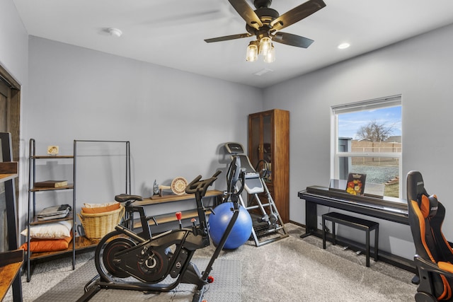 exercise area featuring a ceiling fan, recessed lighting, carpet flooring, and baseboards