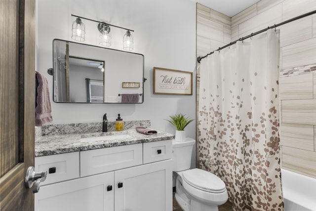 bathroom with shower / bath combo with shower curtain, vanity, and toilet