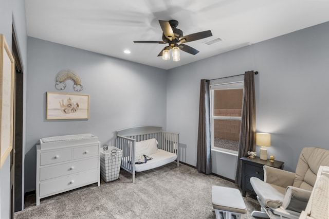 carpeted bedroom with a crib, visible vents, a ceiling fan, and recessed lighting