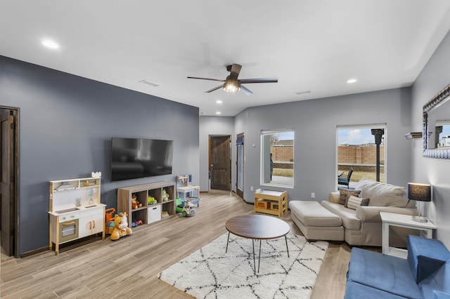 living area with visible vents, ceiling fan, light wood-style flooring, and recessed lighting