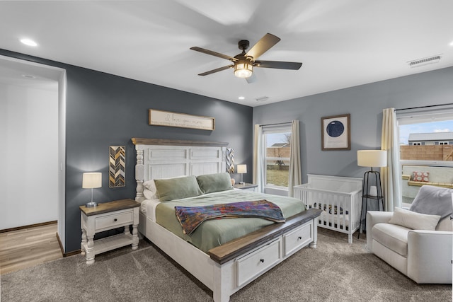 bedroom featuring recessed lighting, visible vents, baseboards, and multiple windows