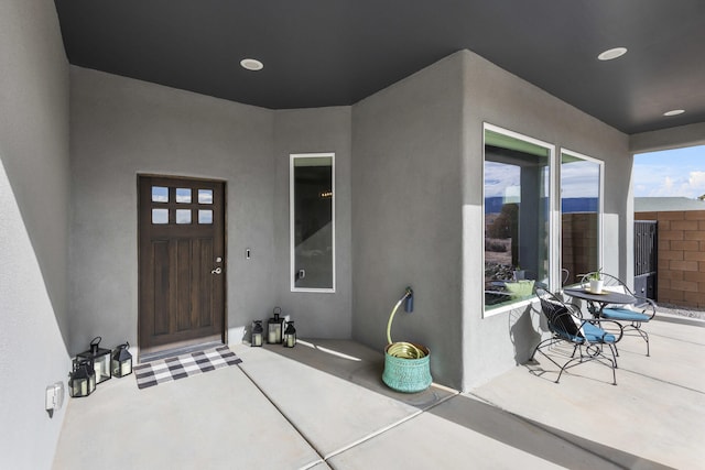 entrance to property featuring stucco siding