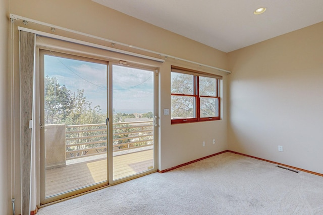 empty room with carpet floors and plenty of natural light