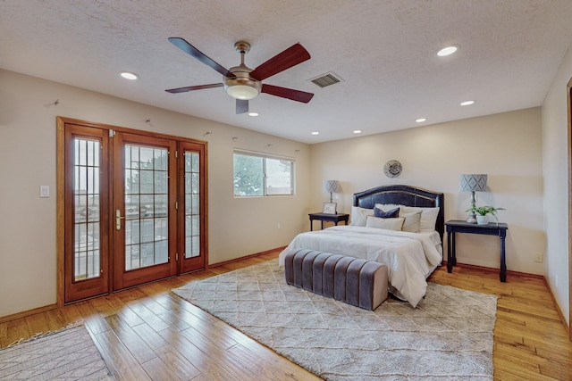 bedroom featuring ceiling fan, access to exterior, light wood-type flooring, and a textured ceiling