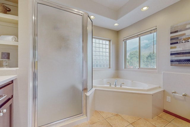 bathroom featuring tile patterned floors, vanity, and plus walk in shower