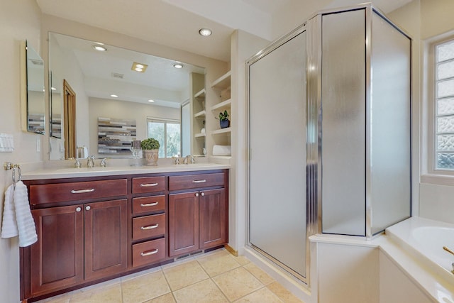 bathroom featuring tile patterned floors, vanity, and shower with separate bathtub