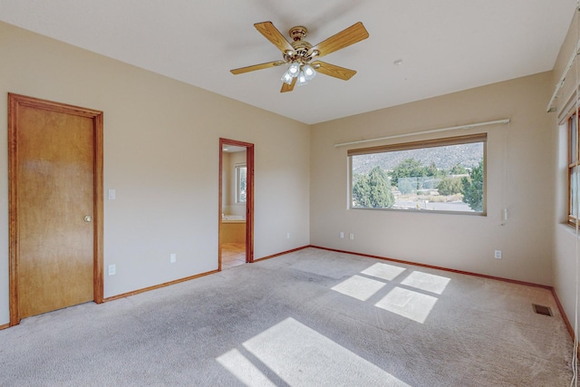 carpeted empty room with ceiling fan