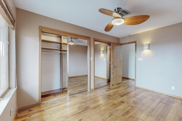 unfurnished bedroom with ceiling fan and light wood-type flooring