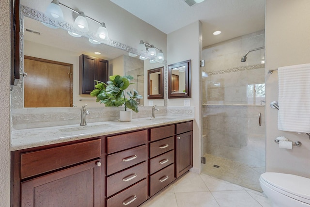 bathroom with tile patterned floors, vanity, toilet, and an enclosed shower