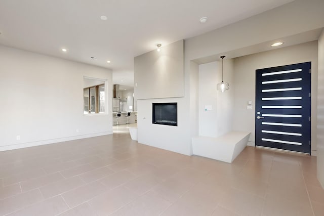 unfurnished living room featuring light tile patterned floors and a fireplace