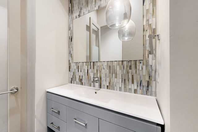 bathroom with vanity and tasteful backsplash