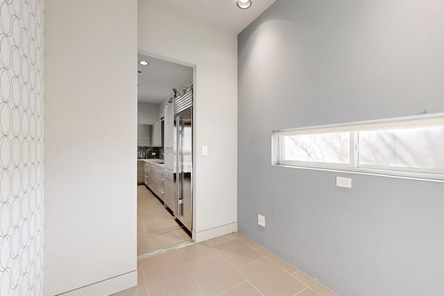 corridor featuring light tile patterned flooring