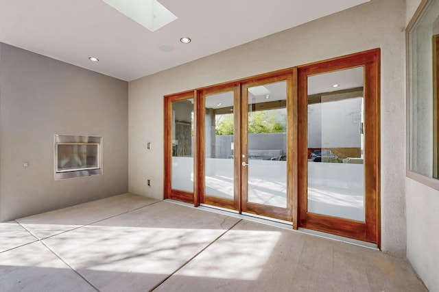 doorway to outside featuring french doors and a skylight