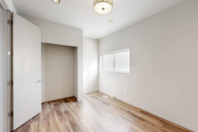 unfurnished bedroom with light wood-type flooring