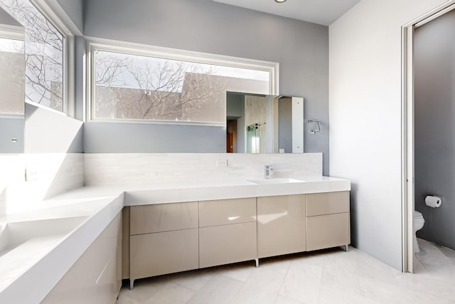 bathroom featuring vanity and toilet