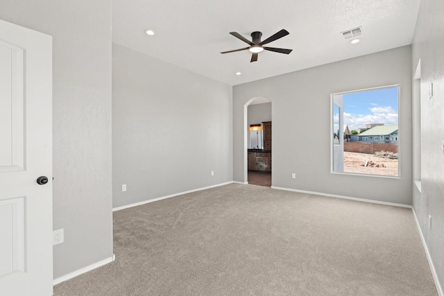 empty room featuring ceiling fan and carpet floors